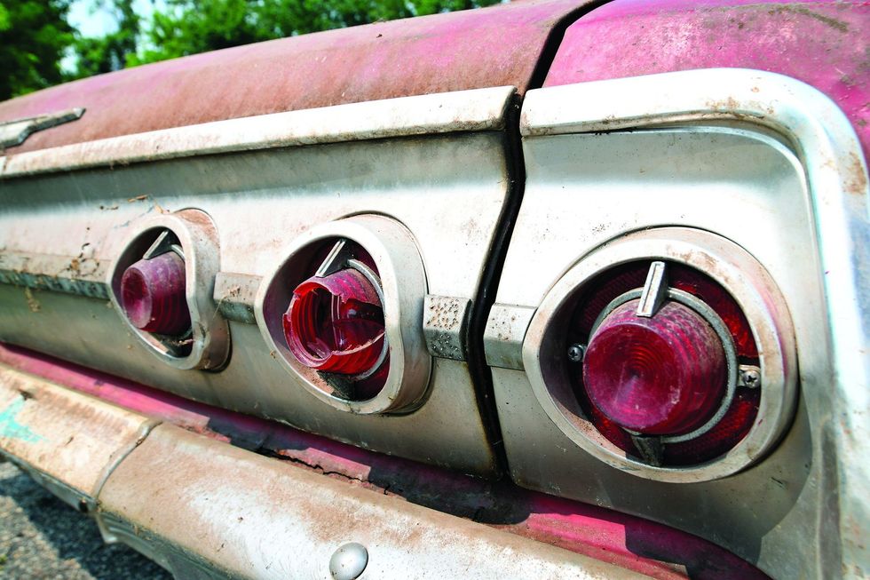 Color closeup of the tail lamps on a 1962 Chevrolet Impala barn find.