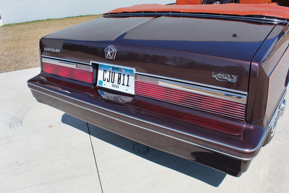 Color closeup of the trunk, tail lamps, license plate and rear bumper on a 1982 Chrysler LeBaron Medallion Mark Cross edition car.