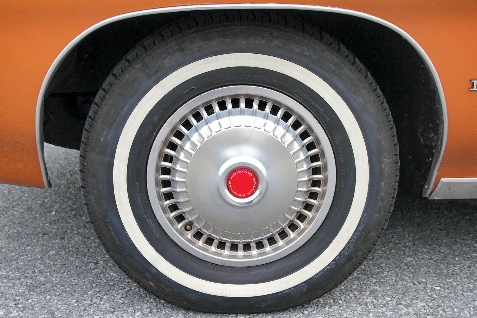 Color closeup of the wheel and tire on a 1972 Pontiac Le Mans.