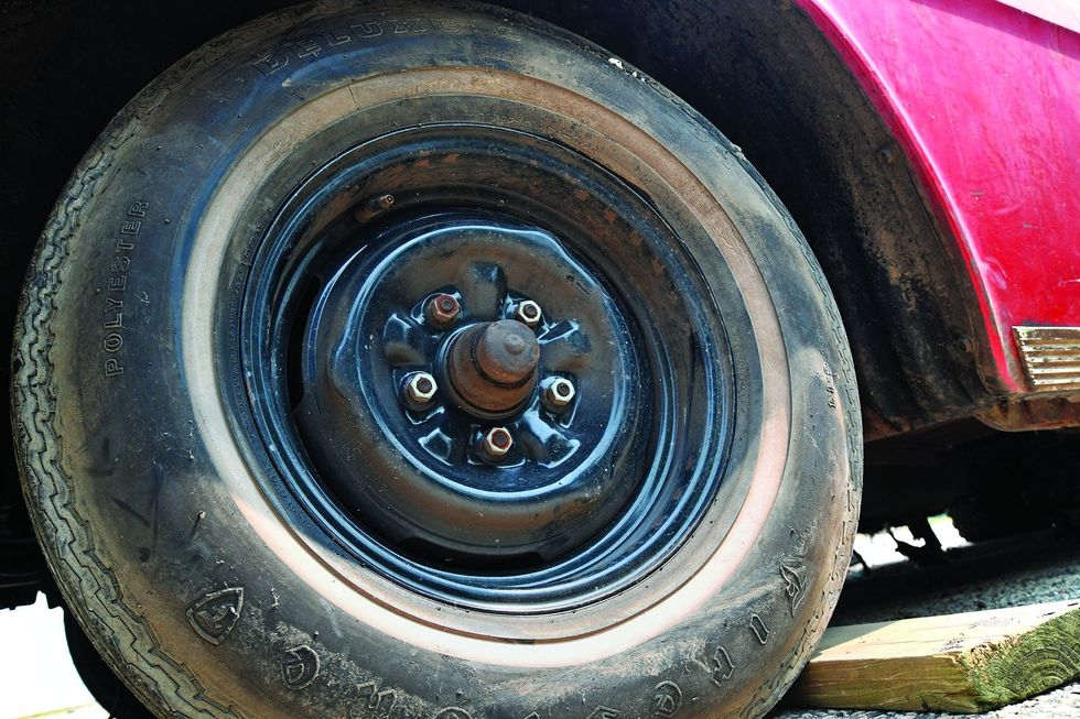 Color closeup of the wheel/tire on a 1962 Chevrolet Impala barn find.