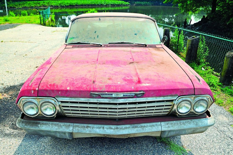 Color image of a 1962 Chevrolet Impala barn find parked in a head-on position.