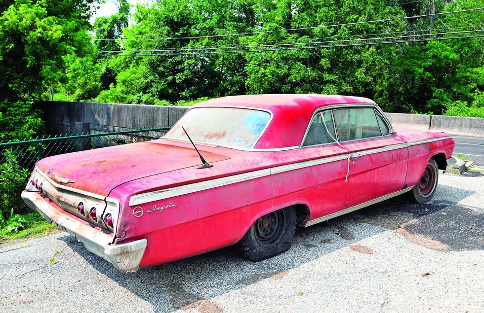 Color image of a 1962 Chevrolet Impala barn find parked in a rear 3/4 position.