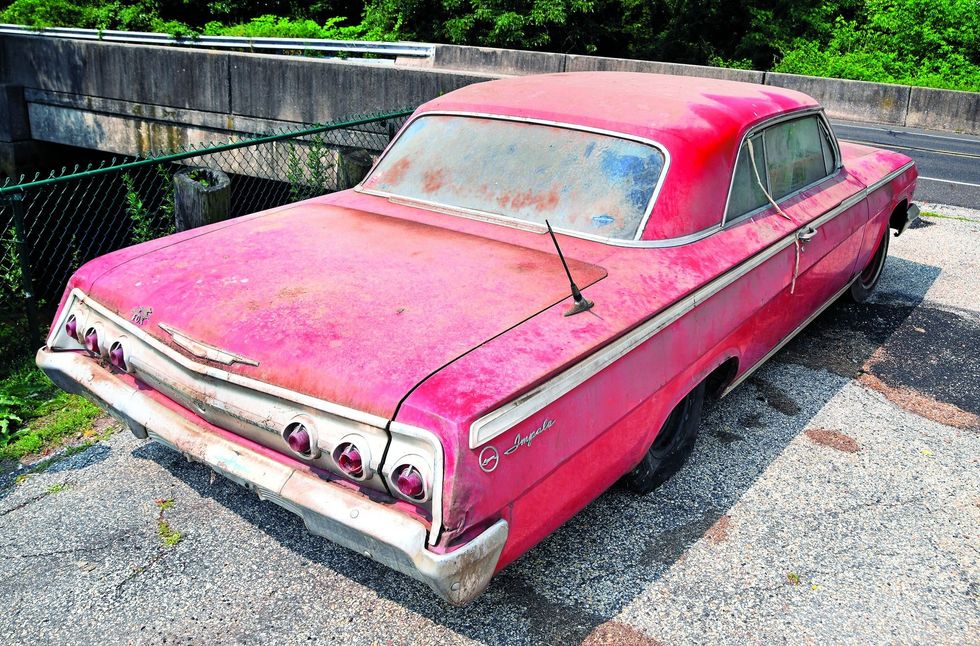 Color image of a 1962 Chevrolet Impala barn find parked in a rear 3/4 position.