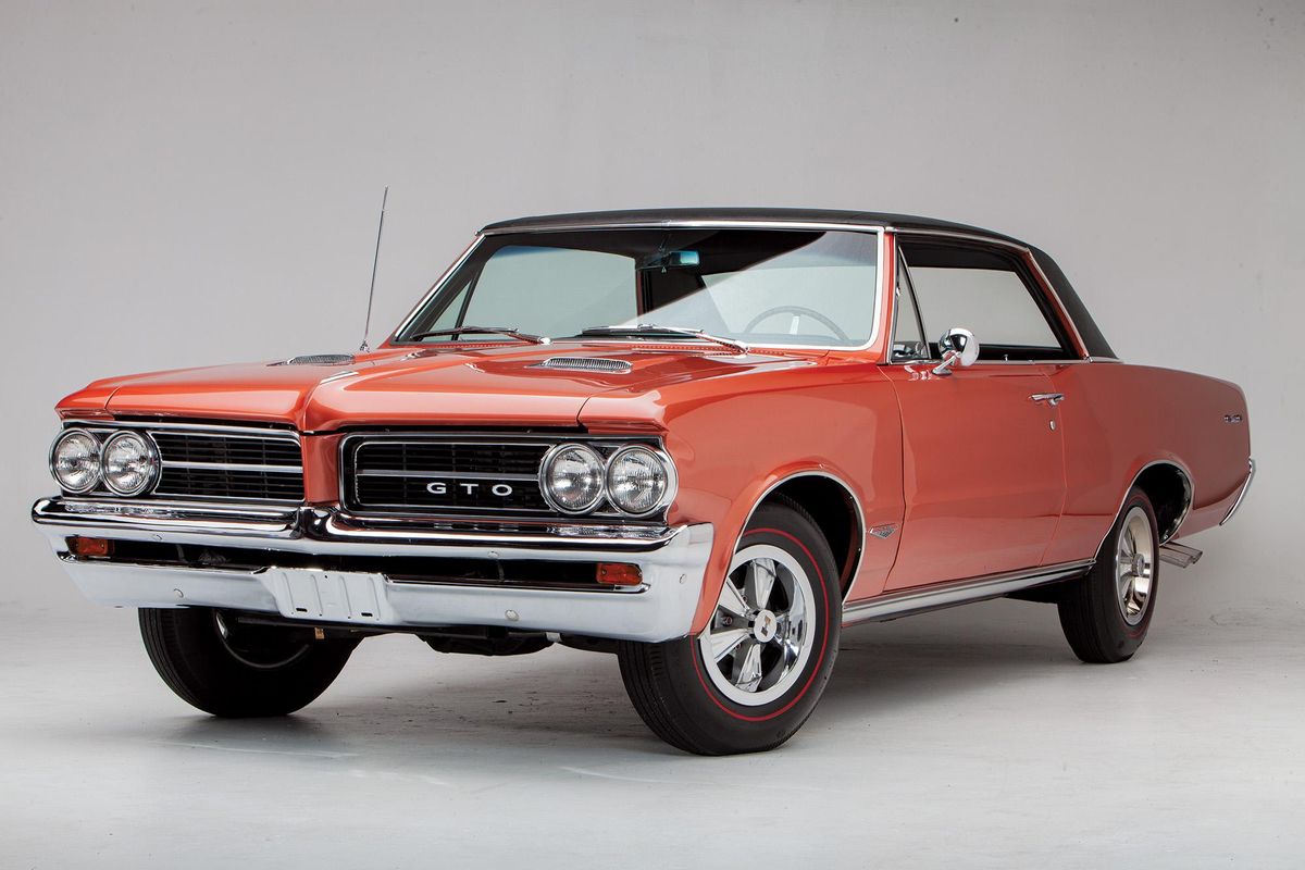 Color image of a 1964 Pontiac GTO parked in a front 3/4 position, studio shot.