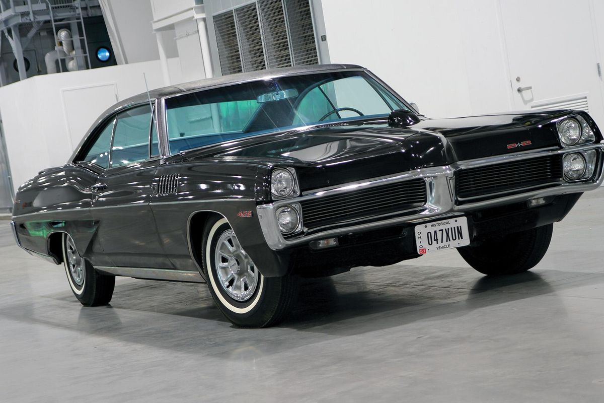 Color image of a 1967 Pontiac Catalina 2+2 parked on the floor indoors at a front 3/4 position.