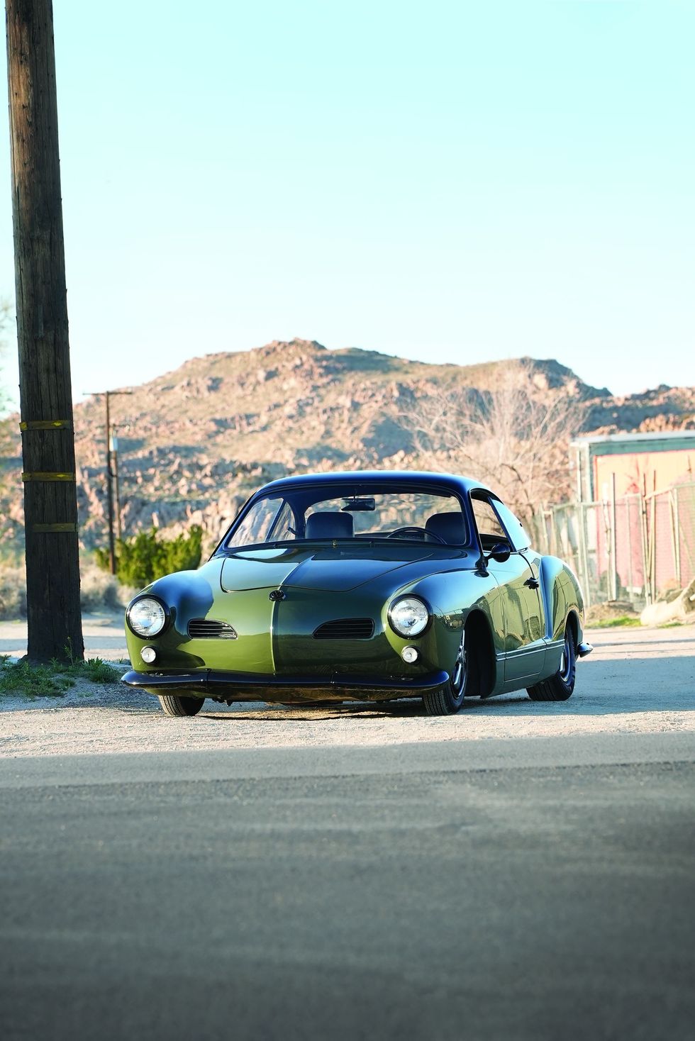 Color image of a customized 1965 Volkswagen Karmann Ghia parked in a front 3/4 position.