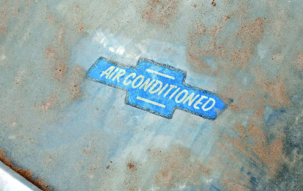Color image of Chevy A/C decal on a 1962 Chevrolet Impala barn find.