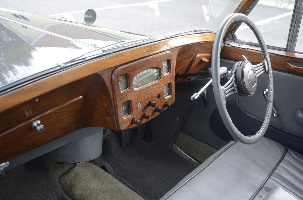 Color image of the dash and steering wheel of a Triumph Town & Country, RHD.