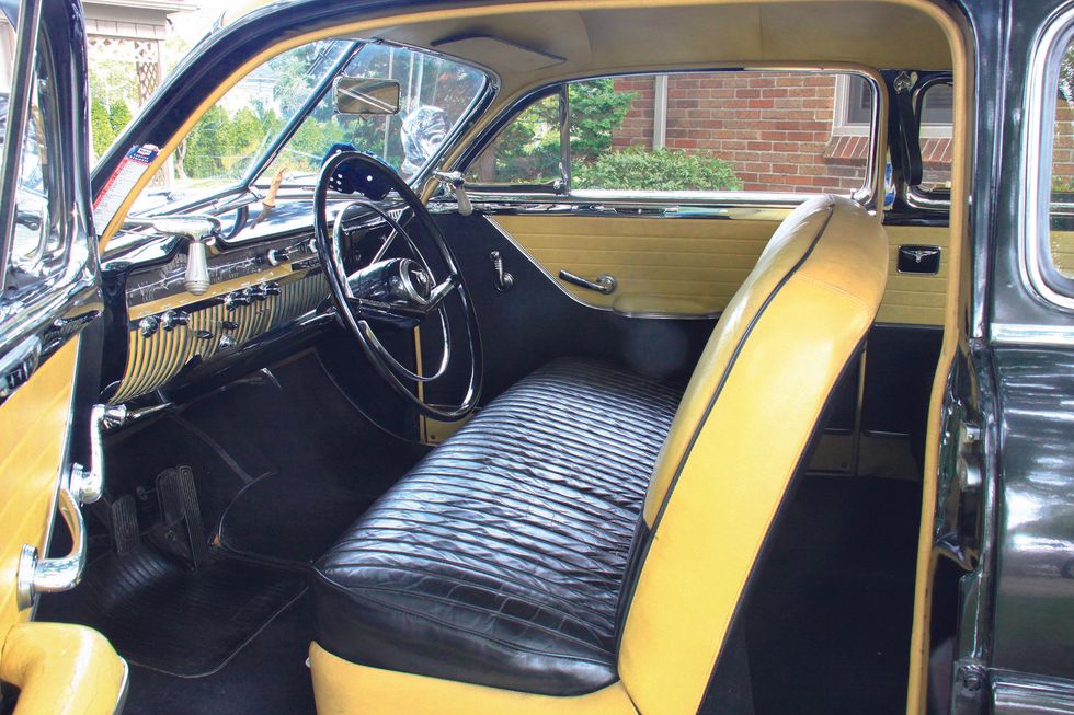Color image of the interior, dash, steering wheel, door panel, seats and more in a 1950 Mercury Monterey Sport Coupe.
