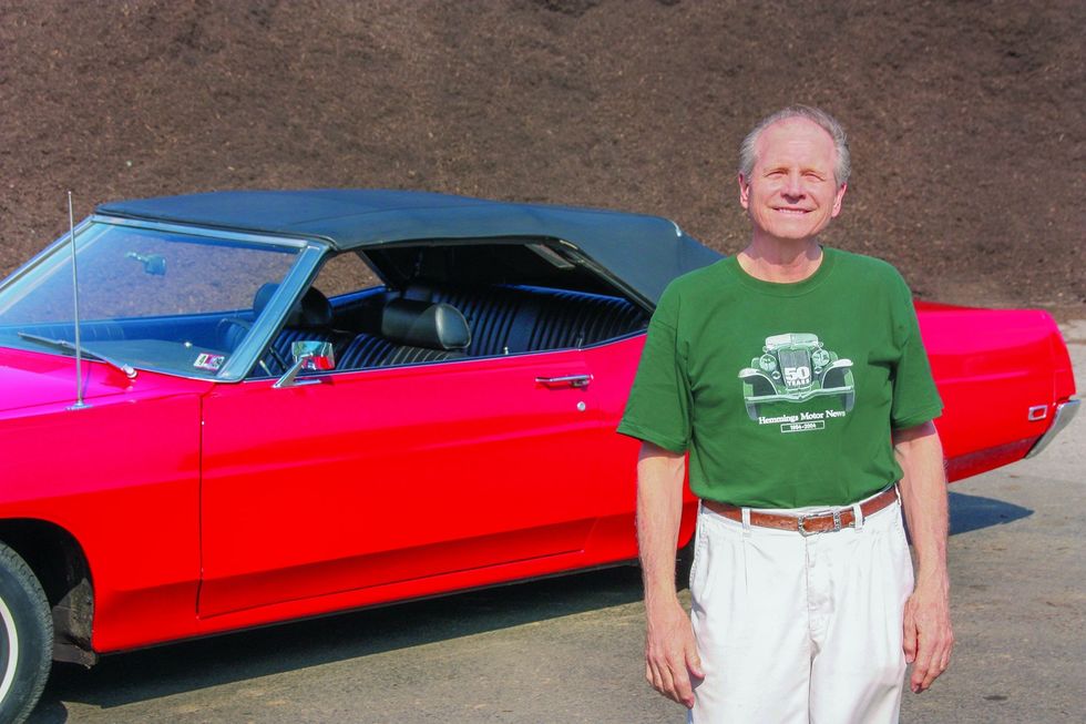 Color image of the owner posing in front of his 1969 Ford XL convertible.