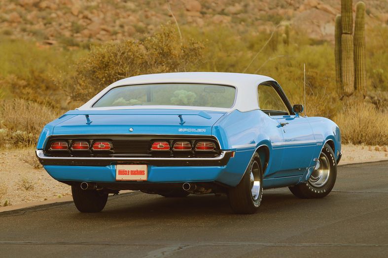 Color rear 3/4 image of a 1970 Mercury Cyclone Spoiler, parked on the road in the desert.