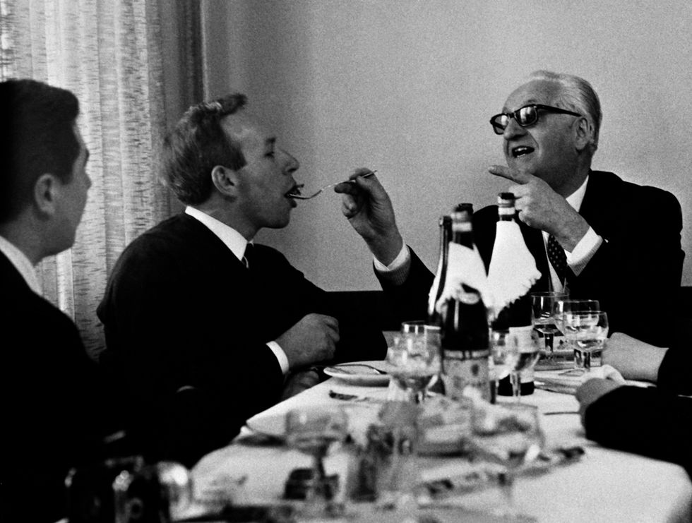 Enzo Ferrari feeding John Surtees lunch (date/location unknown)