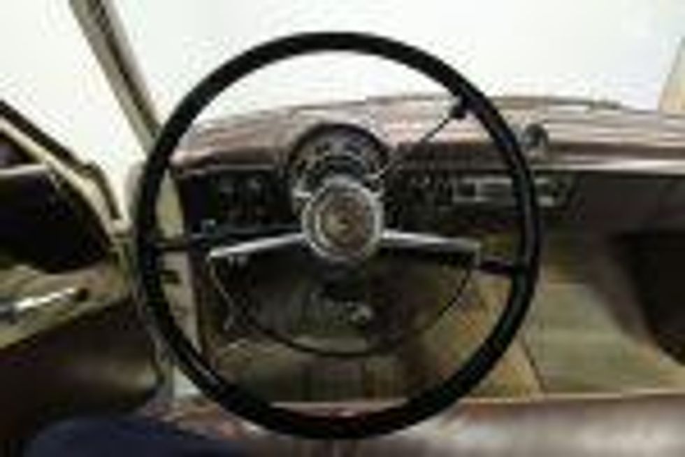 Steering wheel and instruments of a 1953 Ford.