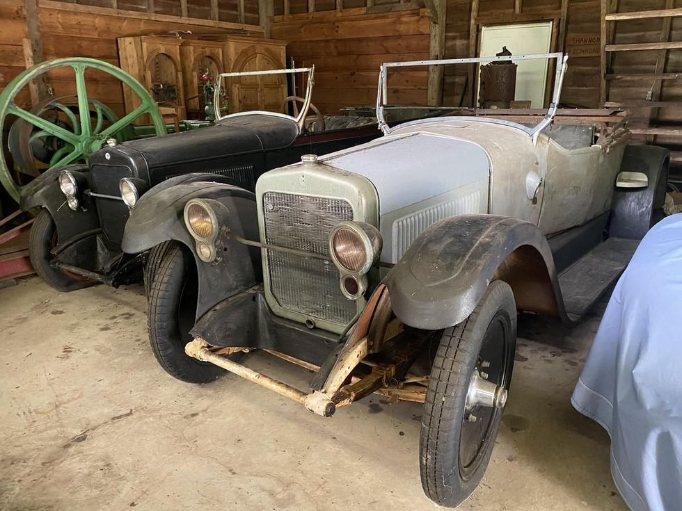 two 1923 Wills Sainte Claire phaeton and roadster needing restoration, in a barn